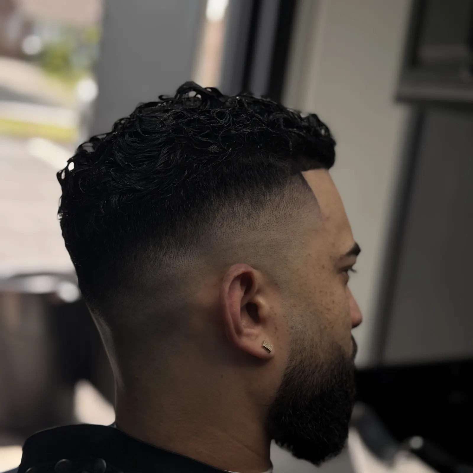 Curly top fade with textured curls