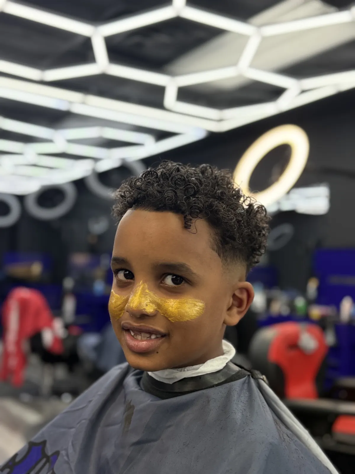 Kids curly fade haircut, smiling client