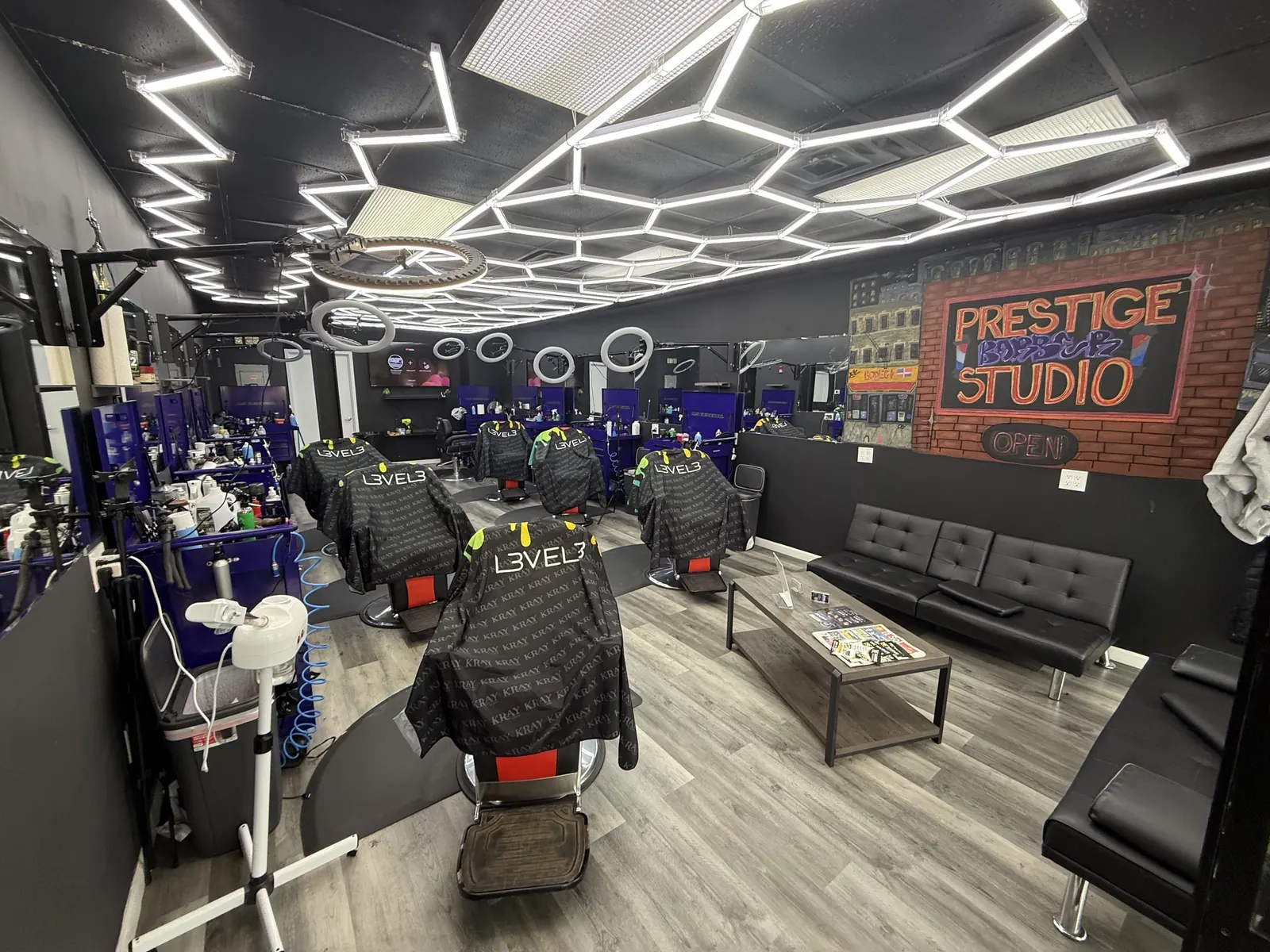 Inside Prestige Barbershop, hexagon LED ceiling and chairs